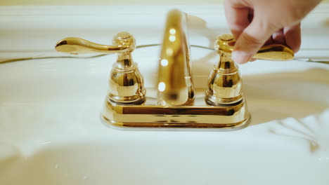 open a tap with water in a luxurious bathtub