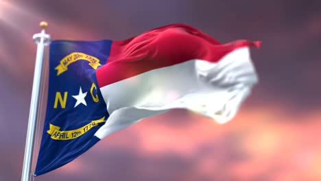 flag of american state of north carolina waving at sunset - loop