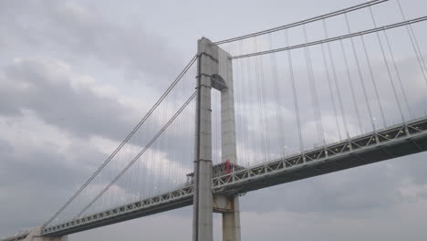 drone shot looking up at the verrazzano-narrows bridge on an overcast day. shot in new york city