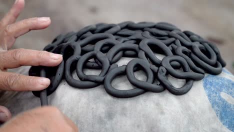 traditional pottery making, close up of potter's hands shaping a bowl on the spinning by clay