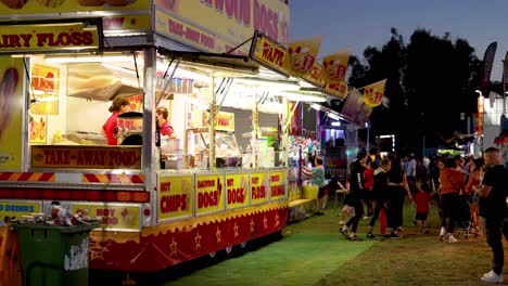 people enjoying food stalls at night fair