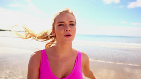 Fit-blonde-jogging-along-the-water