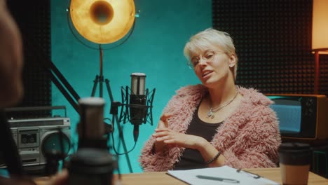 female fashion influencer recording podcast interview in studio