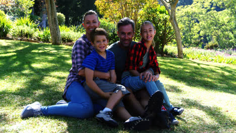 Portrait-of-happy-family-sitting-in-park-4k