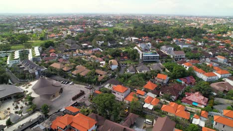 aerial flying over berawa district neighborhood bali residential area rental villas and hotel buildings with orange roofs