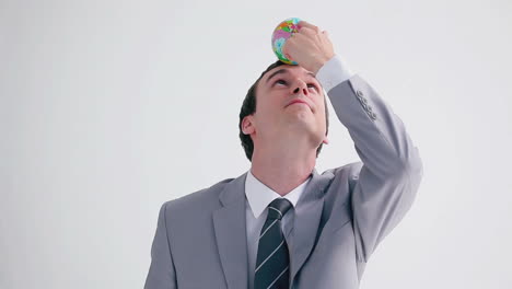 happy executive playing with a small globe ball