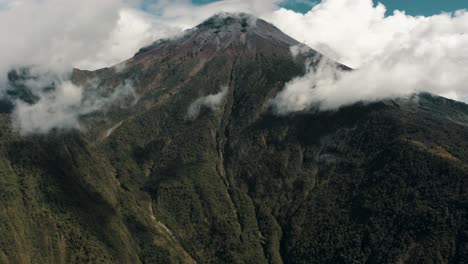 tungurahua volcano with white clouds in baã±os de agua santa, ecuador - drone shot