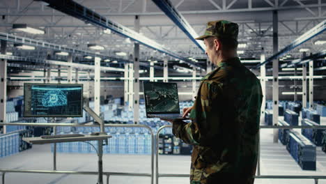 military engineer in data center tracking satellite coordinates using laptop
