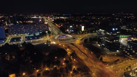 Drone-view-of-busy-city-at-night,-Katowice,-Poland