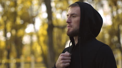 man in a hoodie in autumn park