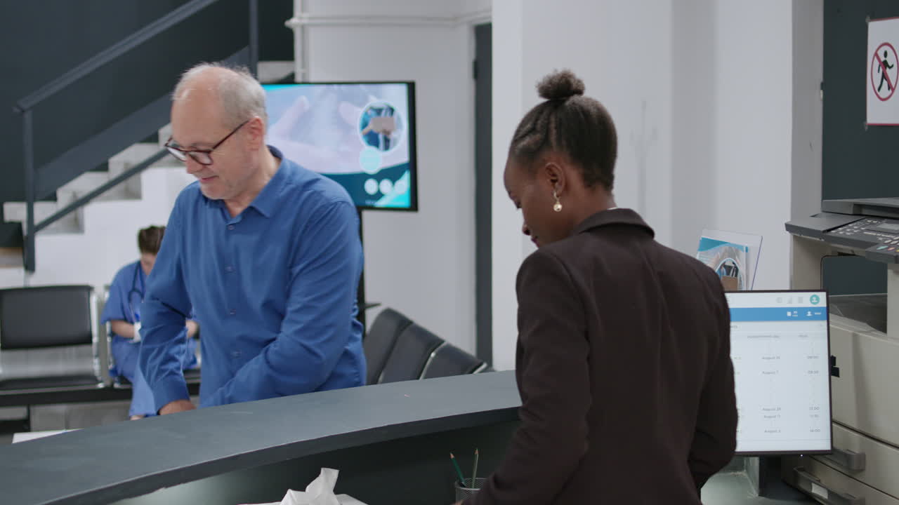 Hospital reception with patient checking in