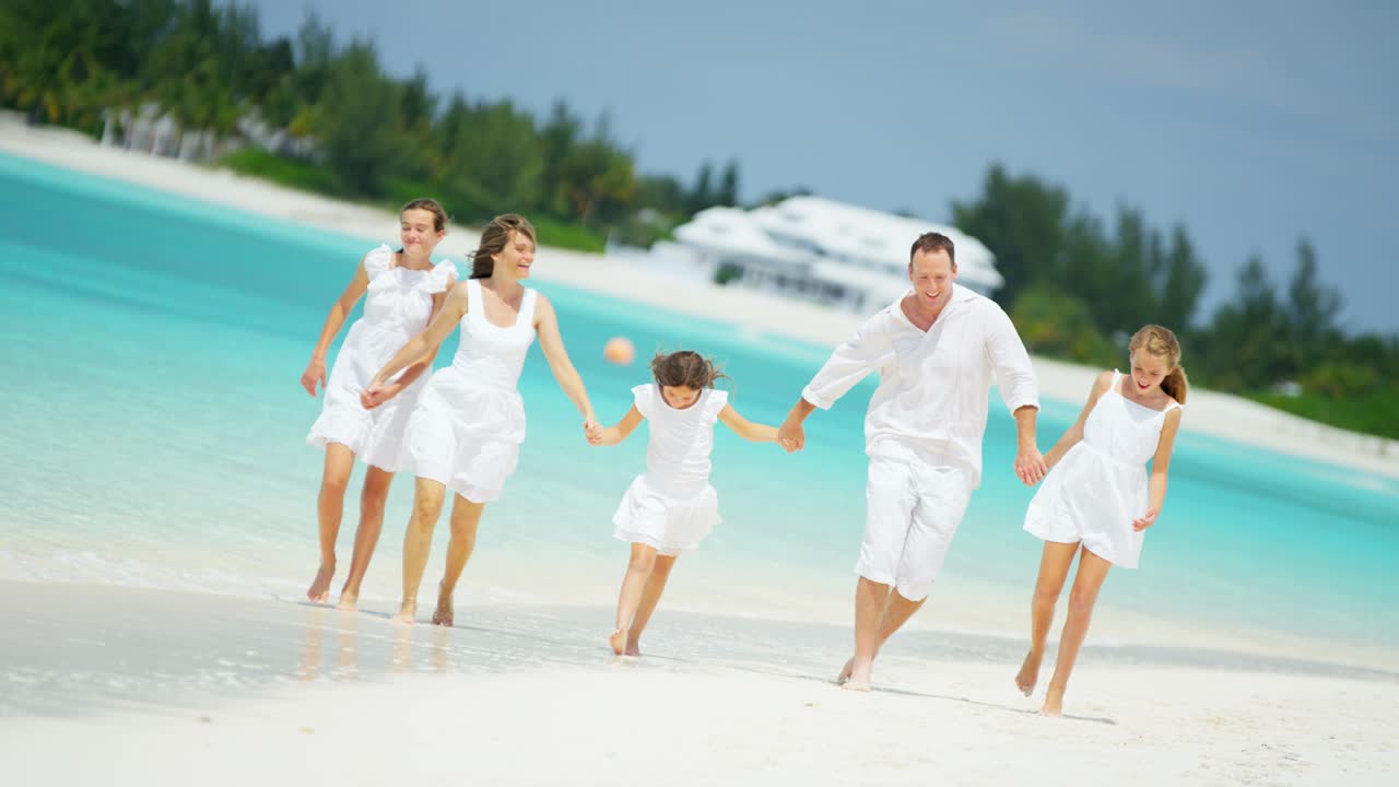열대 해변 에서 산책 하는 행복 한 백인 가족