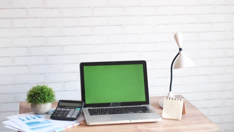 laptop with blank screen on office desk.