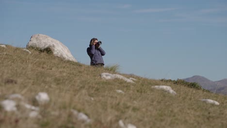 person photographing nature in durmitor national park, montenegro