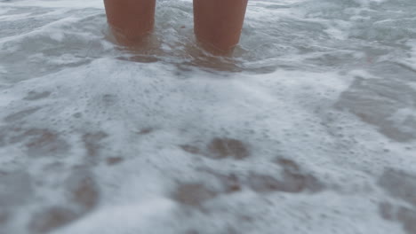 beach waves, feet and freedom of a woman taking