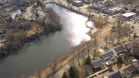 a bright and sunny morning flying over a green pond, shot with a drone