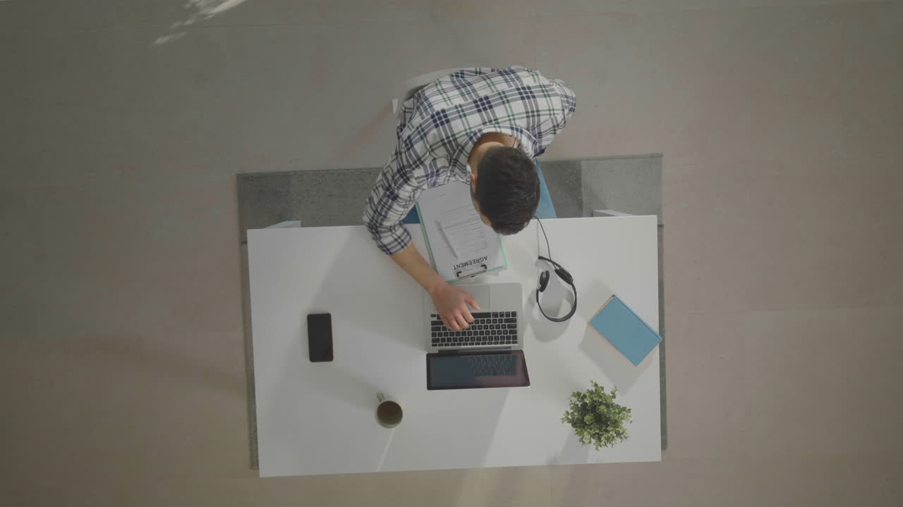 Man sitting, doing some paperwork