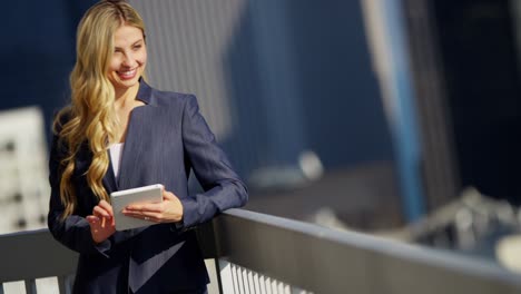 caucasian american businesswoman using tablet on city rooftop