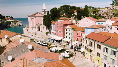 aerial view of boats moored at marina with waterfront hotels, restaurants and church in veli lošinj, croatia