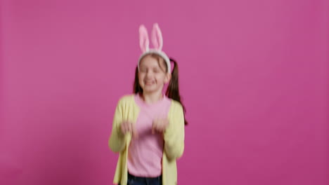 Joyful-carefree-schoolgirl-jumping-around-in-studio