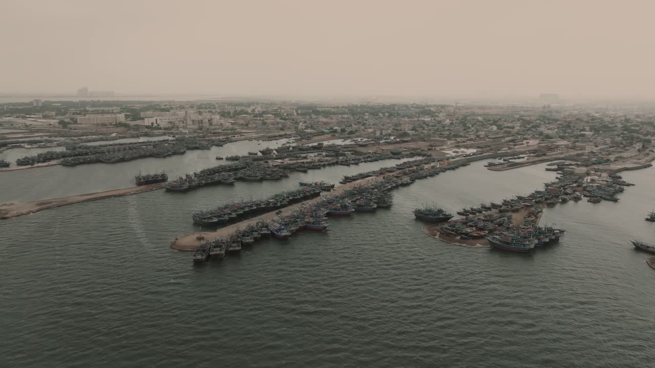 Aerial View Of Fishing Boats Moored Along Jetties At Ibrahim Hyderi In Karachi