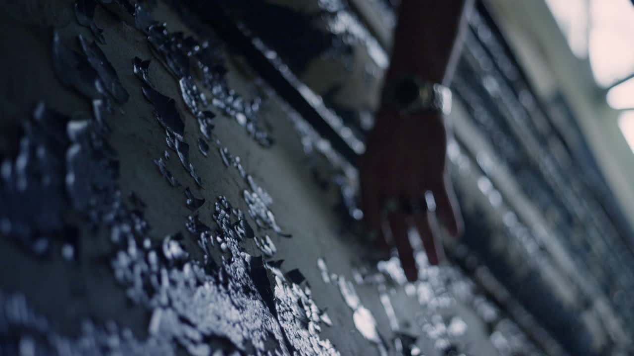 Hand on old paint texture. Old paint wall background. Abandoned wall