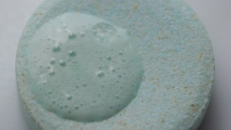 close-up of a bubbling chemical reaction in a glass of water