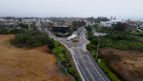 aerial view of a semi truck getting stuck in a roundabout