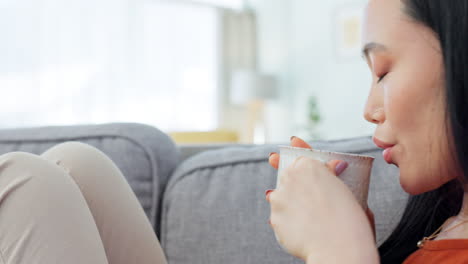 woman relaxing on a sofa drinking coffee/tea