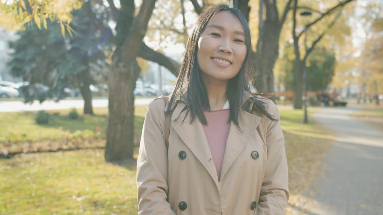 Smiling woman in a park in autumn