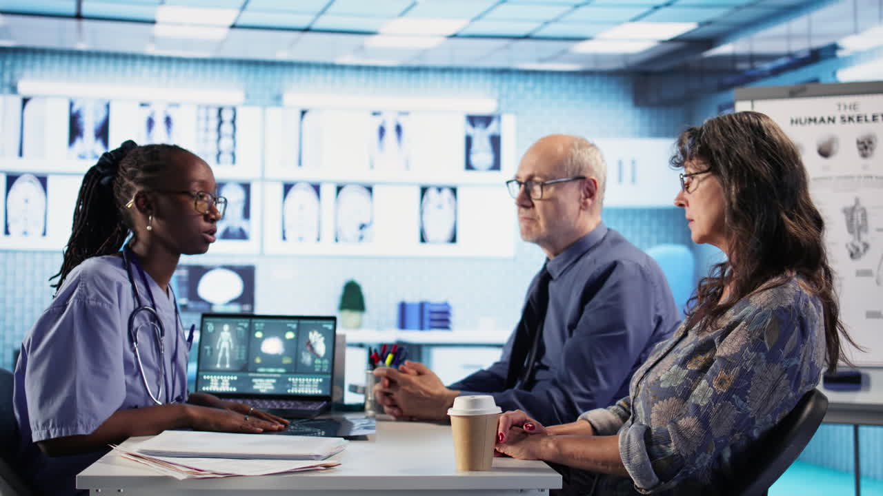 Vertical Video Nurse and patients reviewing diagnostic results in medical cabinet