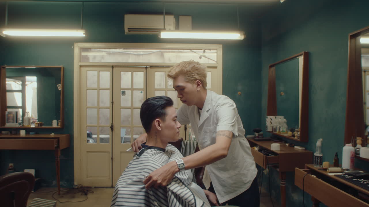 Asian Barber Removing Cape from Client after Finishing Haircut