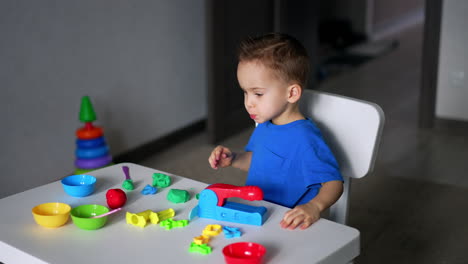 small kid playing with colourful toys. game education for little boy.