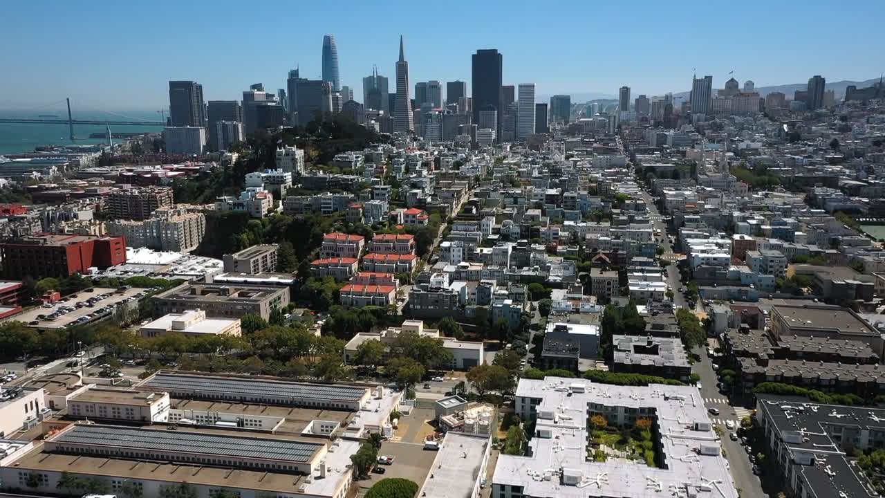 Breathtaking aerial footage of a cascading waterfall over rugged cliffs near San Francisco. Sunlit rocks and verdant foliage create a serene yet powerful natural scene