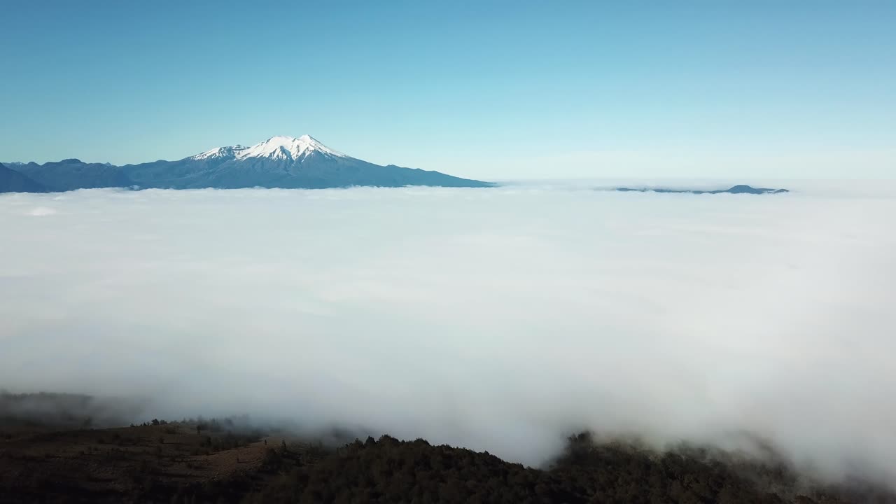 Aerial Panorama of Thick Clouds Above Valley and Forest in Volcanic Region of Chile