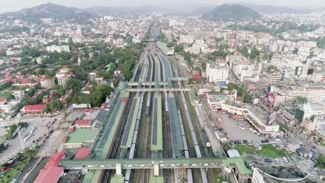 railway dividing indian city with low buildings built into valley surrounded by low hills