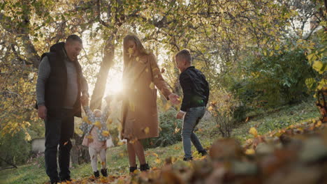 family with two children have fun in autumn park