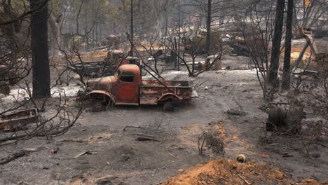 burnt car and nature, aftermath a wildfires in california, usa - handheld view