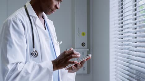 side view of african american male doctor using digital tablet in hospital 4k