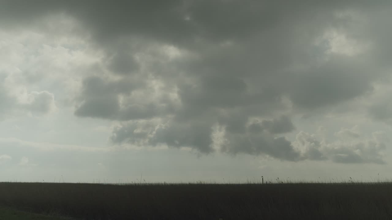 Dramatic Cloudy Sky Over a Grassy Landscape