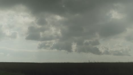 dramatic cloudy sky over a grassy landscape