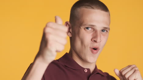 excited young man giving thumbs up