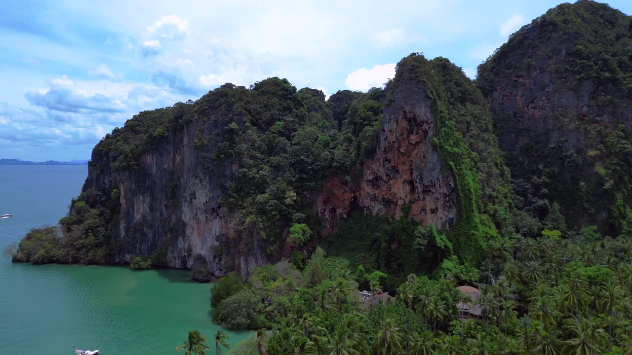 Breathtaking view of Railay beach from a cliff overlooking lush tropical jungle vegetation in Krabi, Thailand. Marvelous aerial view flight panorama overview drone