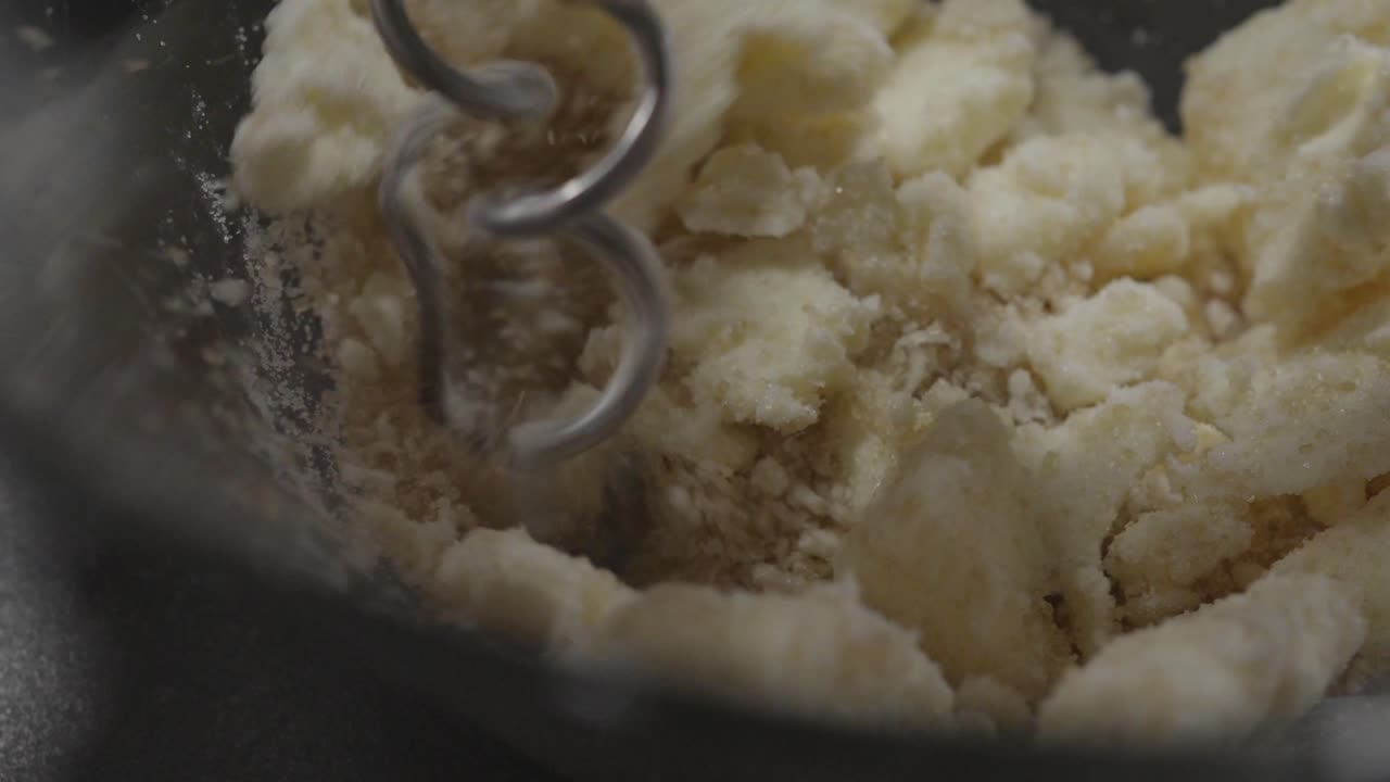 Close Up of Butter and Sugar being mixed by Hand Mixer