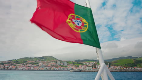 close up shot of portuguese flag waving in the back of the boat