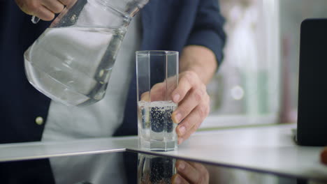 Nahaufnahme-Männlicher-Hände,-Die-Wasser-In-Glas-Gießen