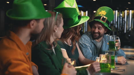 men and women toasting with beer and having fun