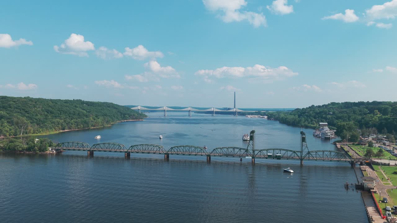 Aerial wide rising shot of the Stillwater Life Bridge over the St. Croix River in downtown Stillwater, Minnesota. 4K