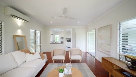 elevated modern loungeroom with wooden floors and beige natural colored furniture