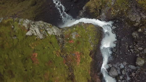 water falls over volcanic cliff into canyon